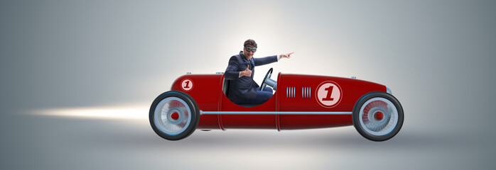 Businessman riding vintage roadster in motivation concept