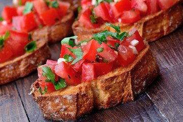 Bruschetta with garlic and tomatoes on table