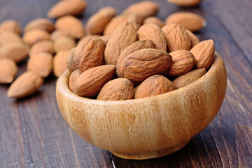 Almonds in a bamboo bowl on table