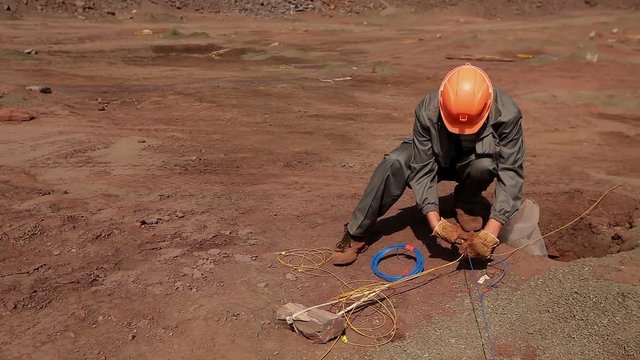 Preparation of an explosion in the quarry, workers are preparing charges, mining of iron ore in the quarry, iron mine, blasting in iron ore quarry, explosion in iron-ore quarry, Iron Ore Mining.