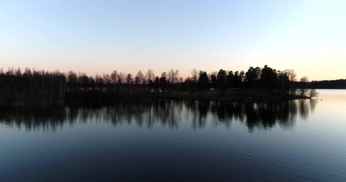 Lake bodom Cinema 4k aerial flight over the golf course, revealing Bodomjarvi, on a sunny spring evening, in Espoo, Finland