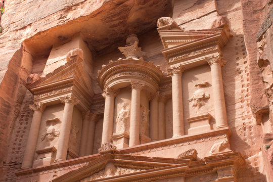 Close up of the Treasury, an ancient building in Petra, Jordan. The orange stone with columns carved by Nabataens is one of the Seven Wonders of the World and is a UNESCO World Heritage Site.