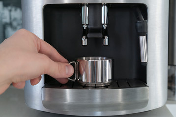 Coffee machine with a metal mug, close up