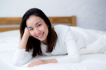 woman beautiful smiling woman portrait wake up early morning after sleeping and lying in bed.