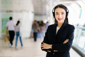 Young female customer service operator with headset and smiling