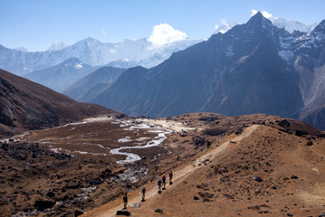 People in Himalaya mountains trekking down to the valley, finishing their journey after reaching Everest Base Camp