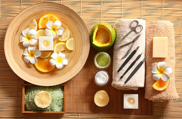Beautiful spa composition of manicure tools and plate on bamboo mat