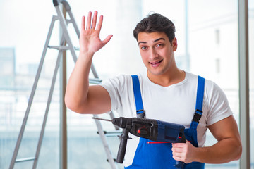 Young worker with hand drill