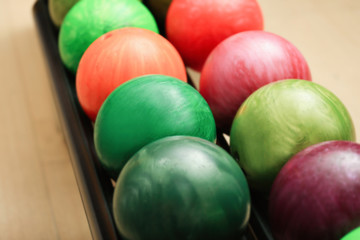Fototapeta na wymiar Colorful balls on rack in bowling club, closeup