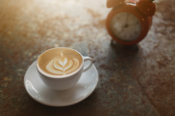 A cup of coffee on rustic background with beautiful latte art.