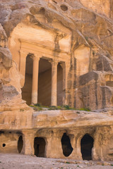 The ancient carved sandstone columns of Siq al Barid, Little Petra, Jordan. Buildings are formed from caves complete with cisterns for water collection. Little Petra was home to the Nabatean people.