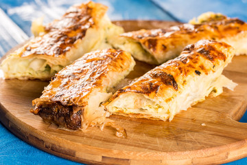 Slices of cheese pie served on the retro rustic wooden board