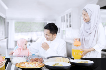 Obraz na płótnie Canvas Happy family eating together in kitchen