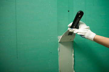 Hands plasterer at work. Application of the plaster on the wall