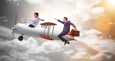 Businessman flying on vintage old airplane