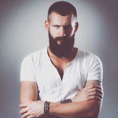 Portrait of handsome man standing, isolated on grey background