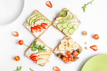 sandwiches set on white table background top view