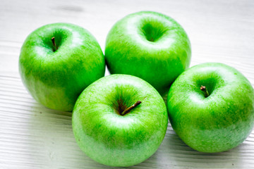 Healthy green food with apples on kitchen white background