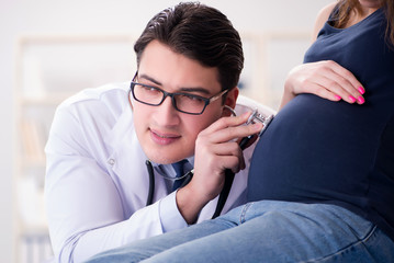 Doctor examining pregnant woman patient