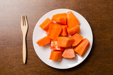 Sliced papaya fruit on white plate ready to eating