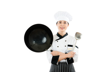female chef showing wok and spatula tools