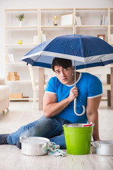 Man at home dealing with neighbor flood leak