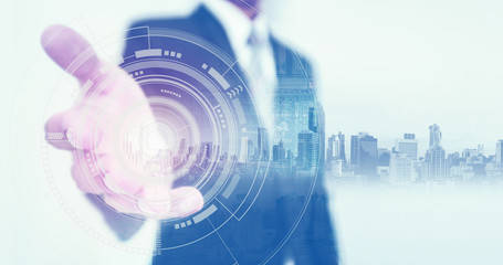 Businessman stretch out hand, with buildings hologram and futuristic interface technology