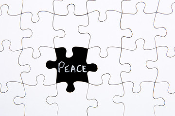 Puzzle Pieces - with word Peace in black chalkboard space
