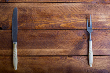 Fork, spoon, knife on the wooden table background with copy place. Concept kitchen and restaurant service. Top view