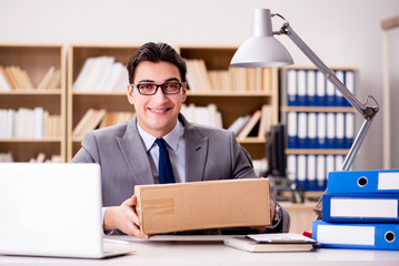 Businessman receiving parcel in office