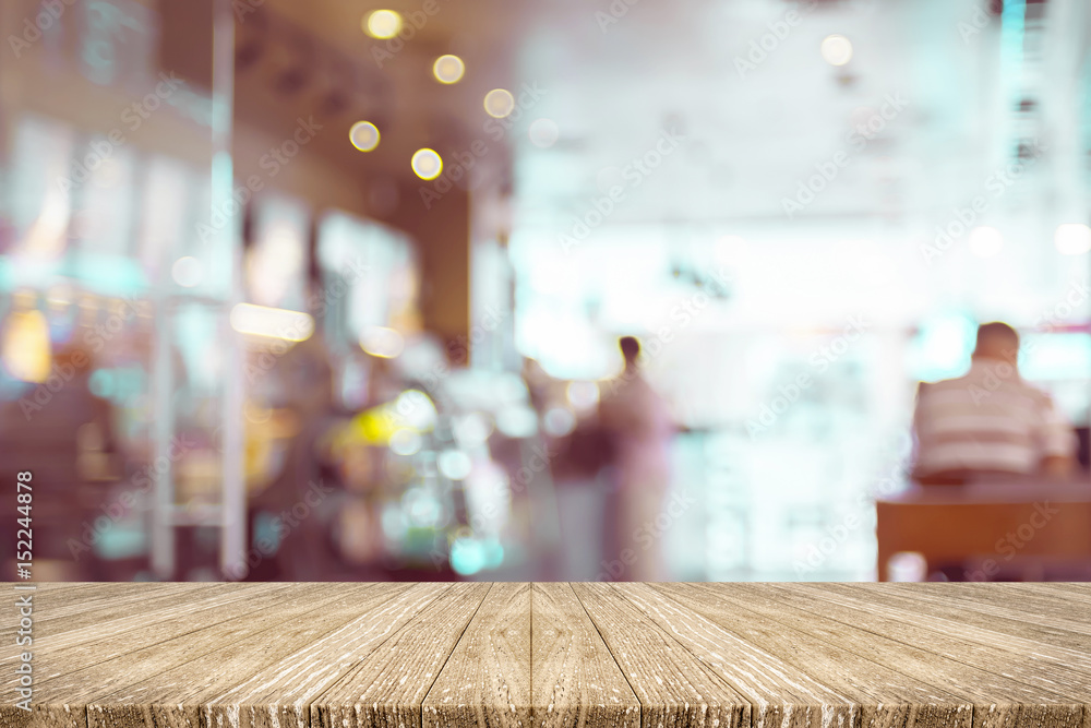 Poster Empty wood plank table top with blur customer in coffee shop with bokeh light,Mock up for display or montage of product,Banner or header for advertise on social media,Food and drink background