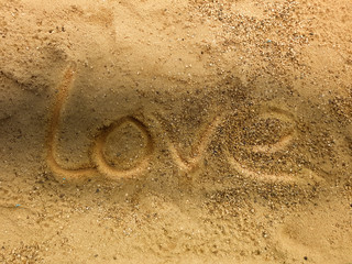 Love symbol handwritten on tropical beach and shadow,Romantic background.