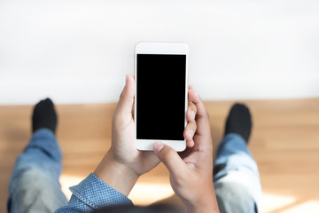 Cropped shot of man's hands holding smart phone with blank copy space  white screen vintage tone copy space