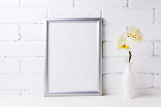 Silver frame mockup with soft yellow orchid in vase