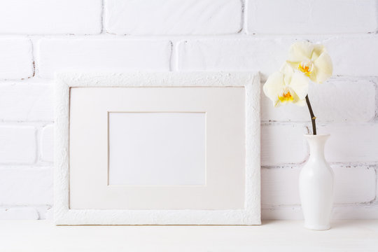White frame mockup with soft yellow orchid in vase