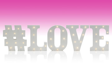 Illuminated Letters Spelling #LOVE Over Gradient Pink-White Background