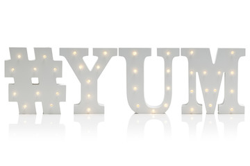 Illuminated Decorative Letters Spelling #YUM Over White Background