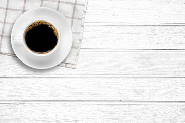 Top view of a white coffee cup on wood background with copy space.