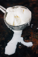 Ice cream starting to melt in metal ice cream scoop.