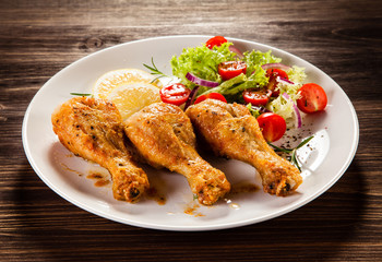 Grilled chicken drumstick on wooden table