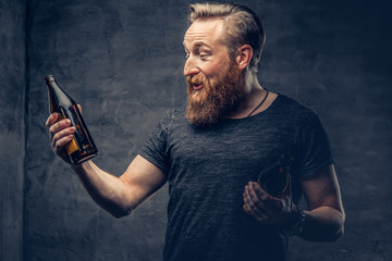 A man holds beer bottle.