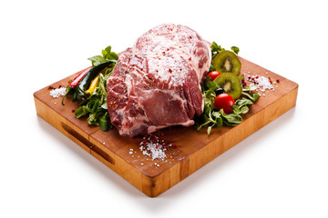 Fototapeta premium Fresh raw pork on cutting board on white background