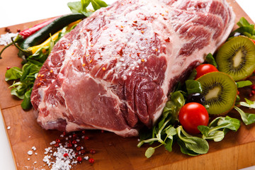 Fresh raw pork on cutting board on white background