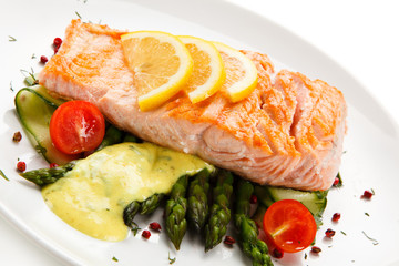 Grilled salmon with asparagus on white background