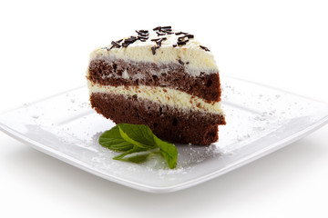 Chocolate cake with icing on white background