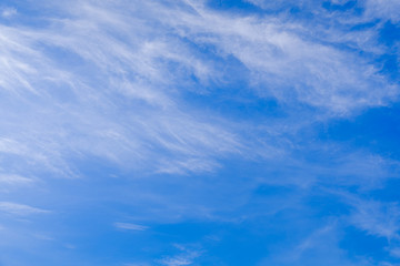 The summer sky is blue with cirrus clouds.