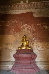 Golden Buddha statue and big aged painting inside Sulamani Temple in Bagan, Myanmar (Burma).