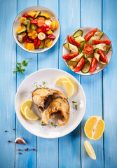 Fried fish with potatoes and vegetables