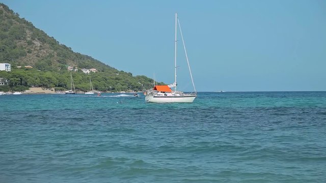 The yacht is anchored next to the beach area. Spanish beaches in Mallorca