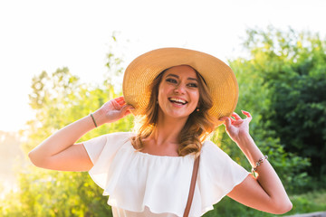 Woman wearing big straw hat enjoyed with summer sun